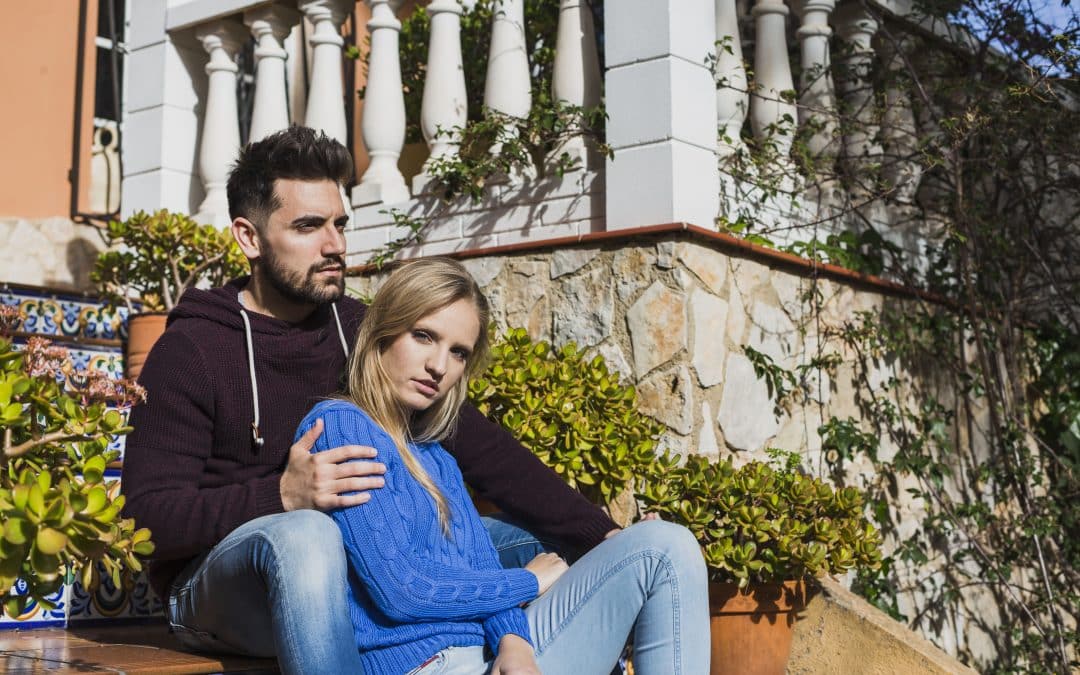 a straight couple on holiday, looking rather disconnected from each other.